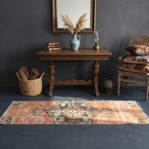 May include: A set of three ceramic vases in varying heights and shapes. The vases are glazed in a matte white finish, offering a minimalist aesthetic. The tallest vase is approximately 10 inches high.