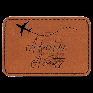 May include: A brown leather luggage tag with a black airplane silhouette, a dotted line, and the text "Adventure Awaits" in a cursive font. The tag also includes the text "Paityn's Designs" in a circle.