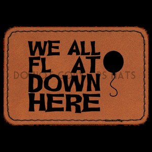 May include: A brown leather patch with black stitching and the text "WE ALL FLAT DOWN HERE" with a black balloon graphic.