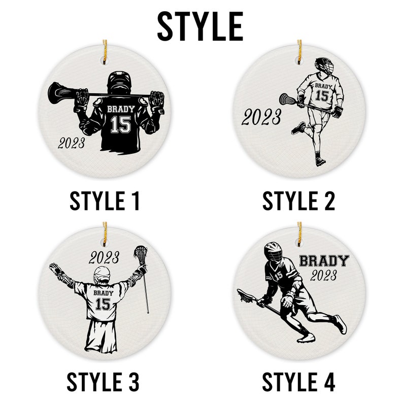 May include: Four different styles of lacrosse player ornaments. Each ornament is round and white with a black lacrosse player design. The player's jersey has the number 15 and the name "BRADY" on it. The year 2023 is also included on each ornament.