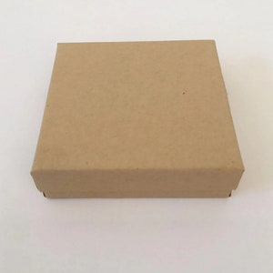 May include: A plain brown cardboard box with a square shape.