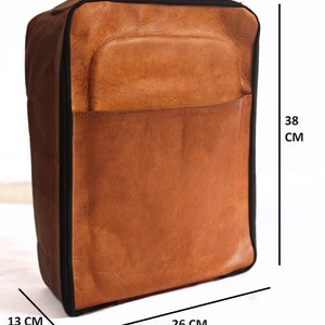 May include: A brown leather travel bag with a black zipper and black trim. The bag measures 13 cm wide, 26 cm long, and 38 cm tall.