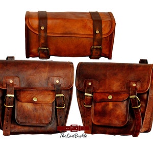 Könnte beinhalten: Drei braune Leder-Motorradsatteltaschen mit Schnallen und Riemen. Die obere Tasche ist rechteckig und die beiden unteren Taschen sind gebogen.