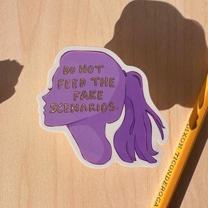 May include: Purple sticker with a silhouette of a woman's head and the text "Do not feed the fake scenarios."