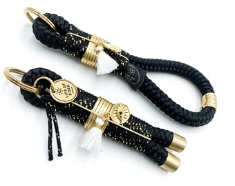 Mini keychain or larger ribbon in black and gold tones is also perfect as a gift idea