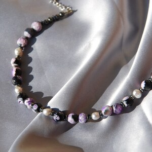 The gemstone necklace "Nyx" made with purple agate, black bloodstones and freshwaterpearls.