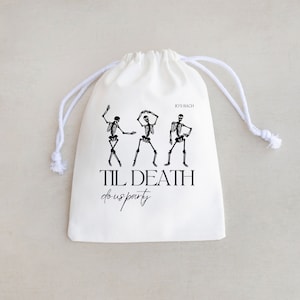 May include: White drawstring bag with a black skeleton graphic and the text "Til Death do us party" and "Boy's Bach" printed on it.