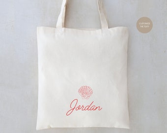 May include: A white canvas tote bag with a red seashell and the name "Jordan" printed on it.