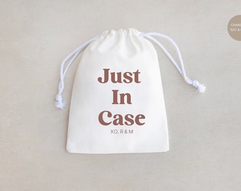 May include: White drawstring bag with the text "Just In Case" in brown lettering and the initials "XO, R&M" printed below.