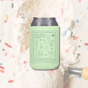 May include: A light green can cooler with a gray top, featuring the text "She's been scooped up!" and ice cream-themed illustrations. The design includes a stamp-like border and the text "Ashley's Bridal Shower."