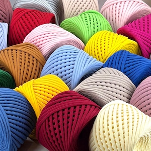 May include: A collection of colorful yarn balls in various shades of blue, green, red, yellow, brown, pink, and white. The yarn is made of a soft, textured material and is perfect for crocheting or knitting.