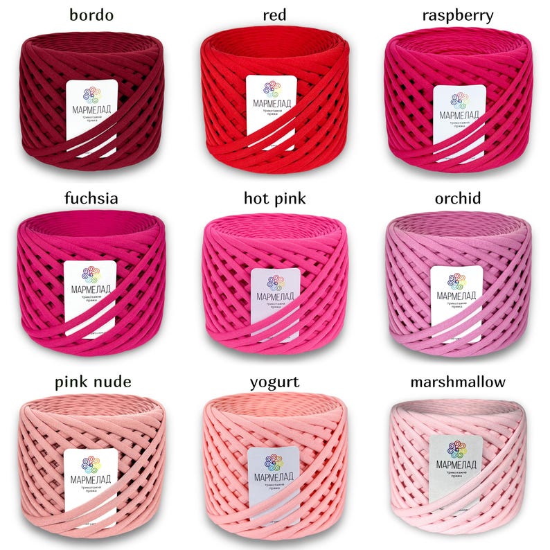 May include: Nine spools of colorful yarn in shades of red, pink, and fuchsia. Each spool is labeled "МАРМЕЛАД".