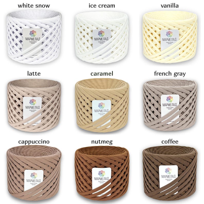 May include: Nine spools of yarn in various shades of brown, beige, and white. The yarn is woven in a basket weave pattern. The spools are labeled with the words "MARMELAD" and the color name, such as "white snow", "ice cream", "vanilla", "latte", "caramel", "french gray", "cappuccino", "nutmeg", and "coffee".