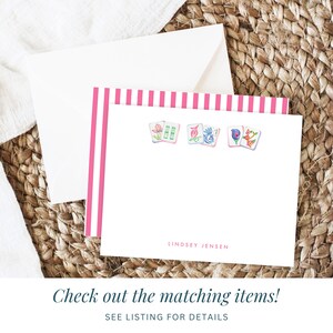 May include: Pink and white striped stationery with a pink border. The stationery features a design of four mahjong tiles with floral and bird illustrations. The name Lindsey Jensen is printed at the bottom of the stationery.