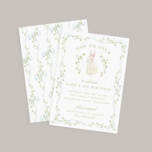 May include: A white bunny with pink ears and nose sits in a wreath of green vines with white flowers. The text "HOP ON OVER" is at the top of the invitation and "to celebrate LARK'S 1ST BIRTHDAY" is below the bunny. The invitation details the date, time, location, and contact information for RSVP.