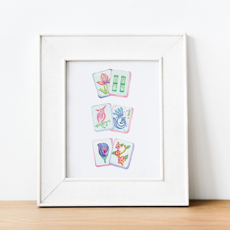 May include: A framed print of watercolor illustrations of mahjong tiles. The tiles feature a variety of designs, including flowers, birds, and bamboo.