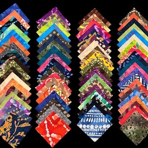 May include: A collection of colorful fabric squares arranged in neat rows. Each square is folded into a triangle, revealing a variety of patterns and colors, including blues, greens, oranges, and purples. The fabric appears to be batik, with intricate designs.