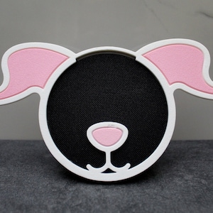 Puede incluir: Marco de fotos con forma de perro blanco y rosa con un centro negro y una nariz rosa.