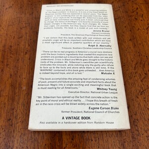 May include: The back cover of a white paperback book titled Crisis in Black and White, featuring printed testimonials from Jerome Bruner, Ralph D. Abernathy, Malcolm X, Whitney Young, and Eugene Carson Blake, with the text A VINTAGE BOOK at the bottom.