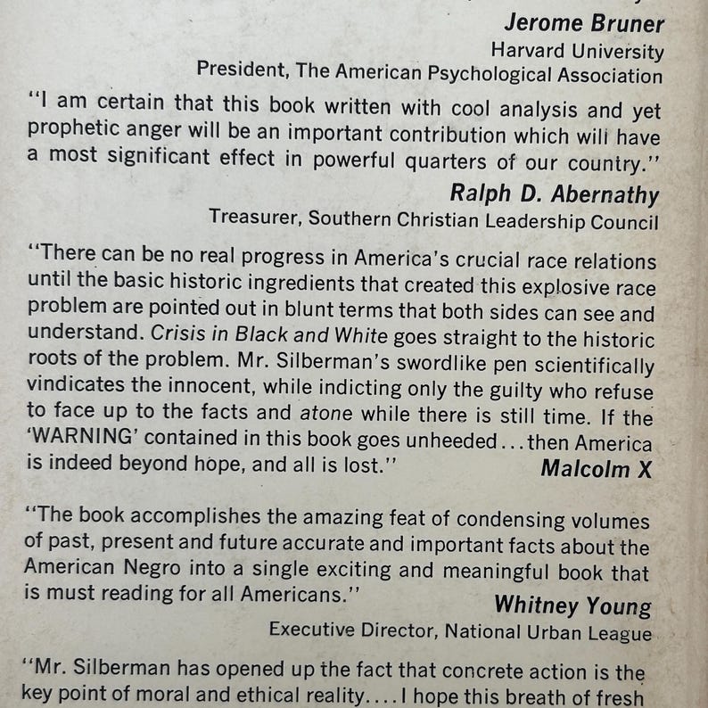May include: A printed page featuring testimonials about the book Crisis in Black and White. It includes quotes from Jerome Bruner, Ralph D. Abernathy, and Whitney Young, with a mention of Malcolm X. The text is black on a light, off-white background.