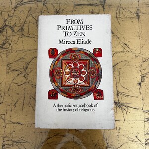May include: A softcover book titled From Primitives to Zen by Mircea Eliade. The white cover features a central circular mandala design in red, gold, and blue, with the subtitle A thematic sourcebook of the history of religions printed below.