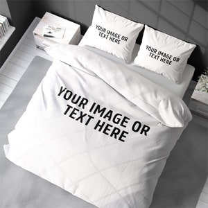 May include: White bedding set with two pillowcases and a duvet cover. The bedding is plain white with the text "YOUR IMAGE OR TEXT HERE" printed on the duvet cover and pillowcases.