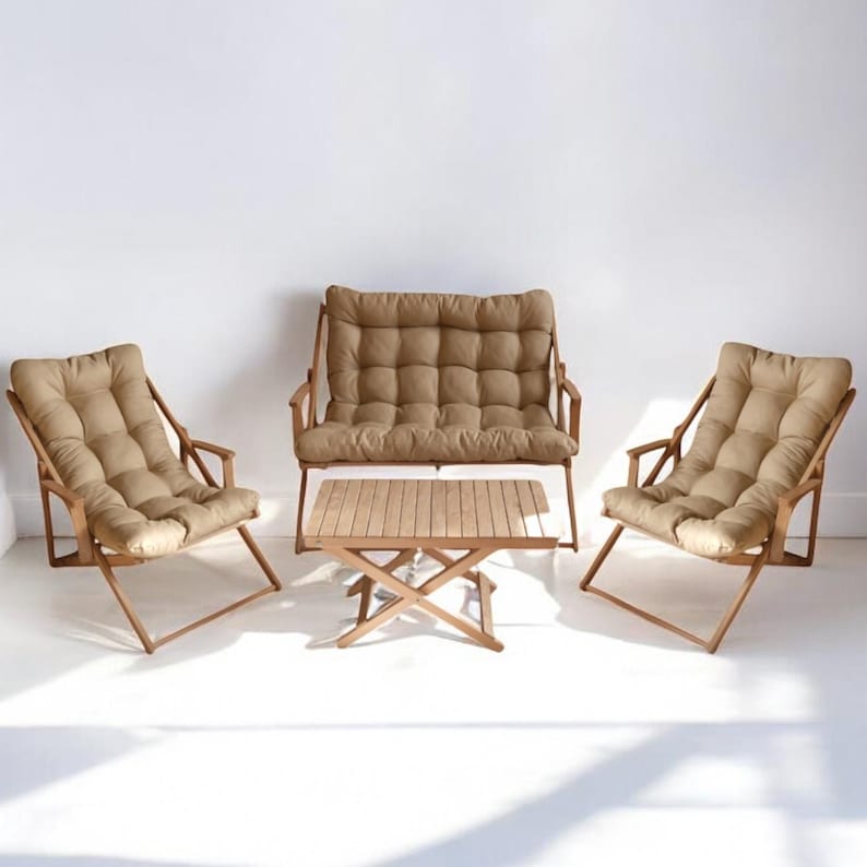 May include: A set of outdoor furniture with a brown wooden frame and beige cushions. The set includes a loveseat and two chairs, as well as a small wooden table.