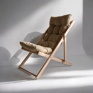 May include: A light brown folding chair with a padded seat and back. The chair is made of wood and has a simple, modern design.