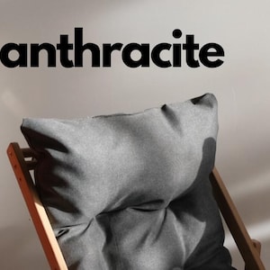 May include: Three wooden chairs with different colored cushions. The cushions are orange, anthracite, and beige.