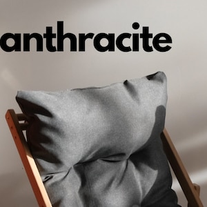 May include: Three wooden folding chairs with cushions in orange, anthracite grey, and beige.