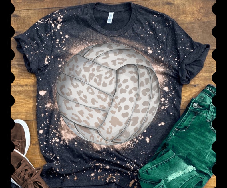 May include: A black t-shirt with a white bleached design of a volleyball with a leopard print pattern.