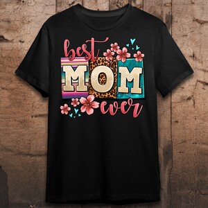 May include: Black t-shirt with the text "best MOM ever" in colorful letters with floral and animal print accents.