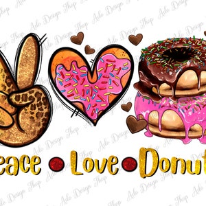 Puede incluir: Gráfico de Paz, Amor, Donuts con un signo de paz, una dona en forma de corazón y una pila de donas con glaseado de chocolate y rosa. El gráfico está en letras doradas brillantes.