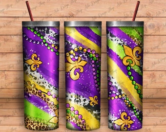 May include: Three stainless steel tumblers with a Mardi Gras theme. The tumblers feature a purple, green, and gold design with beads, fleur-de-lis, and leopard print.
