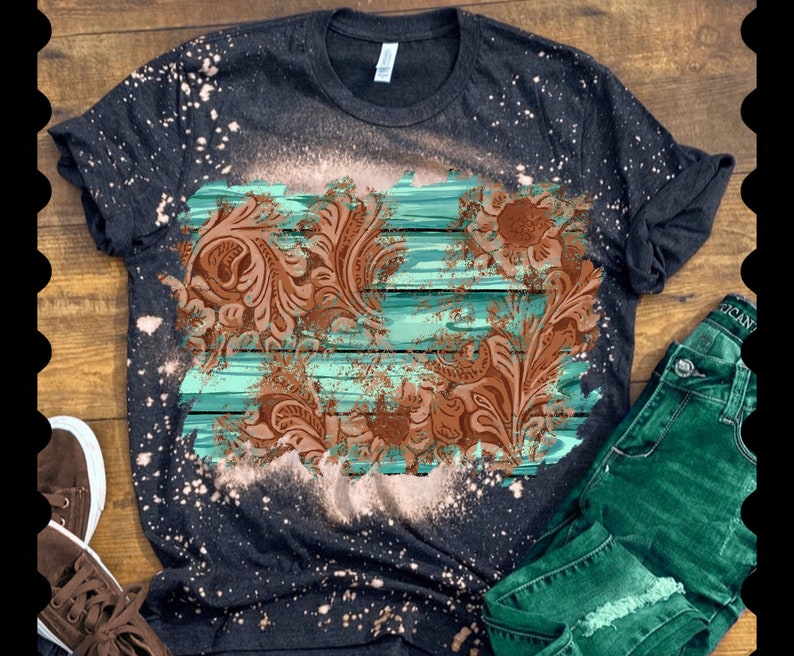 May include: A black t-shirt with a bleach-splattered design featuring a brown floral pattern on a turquoise and white striped background.