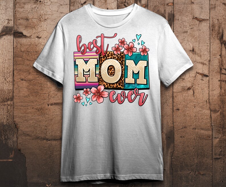 May include: White t-shirt with the text "best MOM ever" in colorful block letters with floral and leopard print accents.