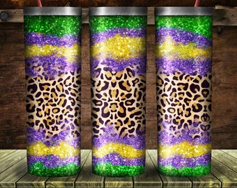 May include: Three stainless steel tumblers with a Mardi Gras theme. The tumblers are decorated with green, purple, and gold glitter, and a leopard print pattern.