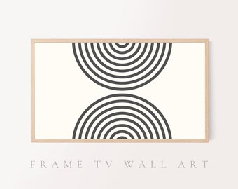 May include: A black and white abstract geometric print with concentric circles in a wood frame. The print features two half circles, one above the other, with the top half circle facing down and the bottom half circle facing up.