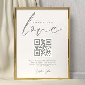 May include: A gold-framed sign with the text "SHARE THE love" in gray script font. A QR code is below the text, and the text "PLEASE SHARE YOUR PHOTOS WITH US. SIMPLY SCAN THE CODE WITH YOUR PHONE'S CAMERA AND UPLOAD TO OUR SHARED GALLERY" is below the QR code. The names "Sarah + John" are written in gray script font below the text.