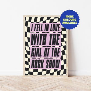 May include: A black and white chequered background with the text "I fell in love with the girl at the rock show" in pink and black lettering.