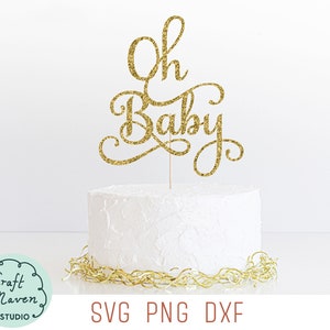 May include: Gold glitter cake topper with the words "Oh Baby" in a cursive font. The topper is on top of a white cake.