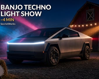 May include: A silver angular electric pickup truck with a prominent horizontal LED headlight strip. The text BANJO TECHNO LIGHT SHOW ~4 MIN SecristWorks is visible. The vehicle features dark geometric wheel covers and a sharp, wedge-shaped body design.