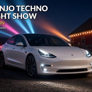 May include: A white electric sedan with illuminated headlights and fog lights parked outdoors at night. The text BANJO TECHNO LIGHT SHOW ~4 MIN SecristWorks is visible above the car, with blue and pink light beams projecting into the sky.
