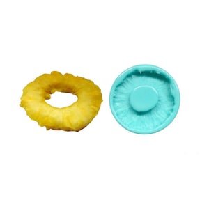 May include: A turquoise silicone mold shaped like a pineapple ring. The mold is designed to create a pineapple ring cake decoration.