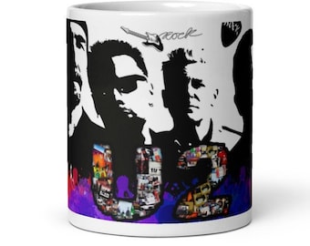 May include: White ceramic mug featuring a collage of black and white portraits of a rock band. The band's name, "U2", is displayed in a collage of images. The word "rock" is written in cursive with a guitar illustration. The bottom has a purple and red gradient.