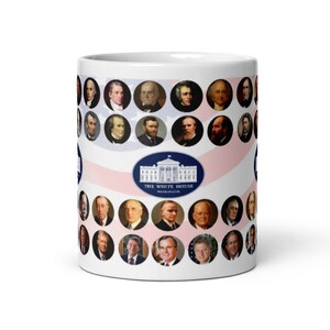 May include: White ceramic mug featuring portraits of U.S. presidents in circular frames. The mug has a design of red and white stripes and an image of the White House with the text "The White House Washington".