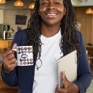 May include: White ceramic mug featuring portraits of U.S. presidents and the White House. The mug has a patriotic design with red and blue stripes. The mug is held by a person wearing a navy blue blazer and a white shirt.