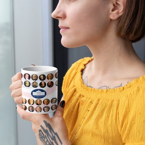 May include: White ceramic mug featuring portraits of U.S. presidents and the White House logo. The mug has a pink and white striped design. The mug is held by a person wearing a yellow top.