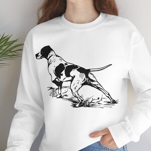 May include: White sweatshirt with a black and white illustration of a hunting dog on the front.