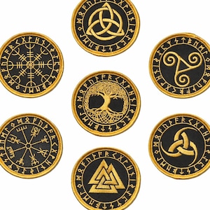 May include: A set of six circular embroidered patches featuring black fabric with gold thread designs. Each patch displays a unique Norse-inspired symbol surrounded by a border of runic characters, including a triquetra, tree, and valknut.